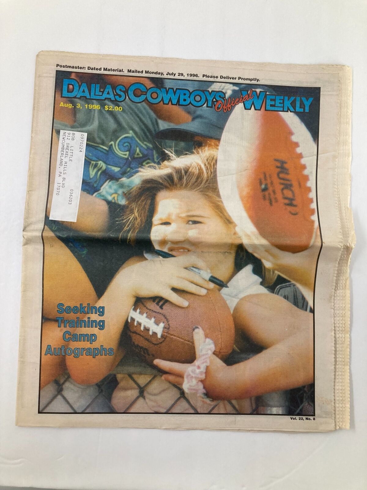 Cover of Dallas Cowboys Weekly Newspaper August 3 1996 Vol 22 #8 featuring a young girl holding a football, promoting training camp autographs.