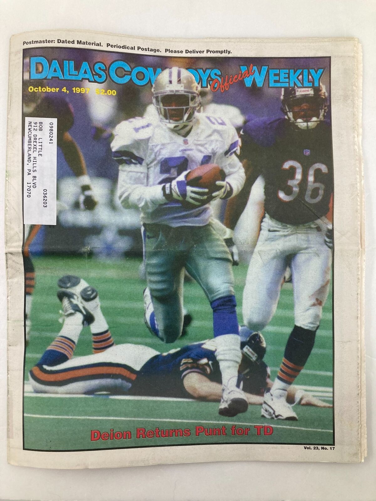Dallas Cowboys Weekly Newspaper October 4 1997 Vol 23 #17 featuring Deion Sanders, showcasing him running with the football as two defenders close in.