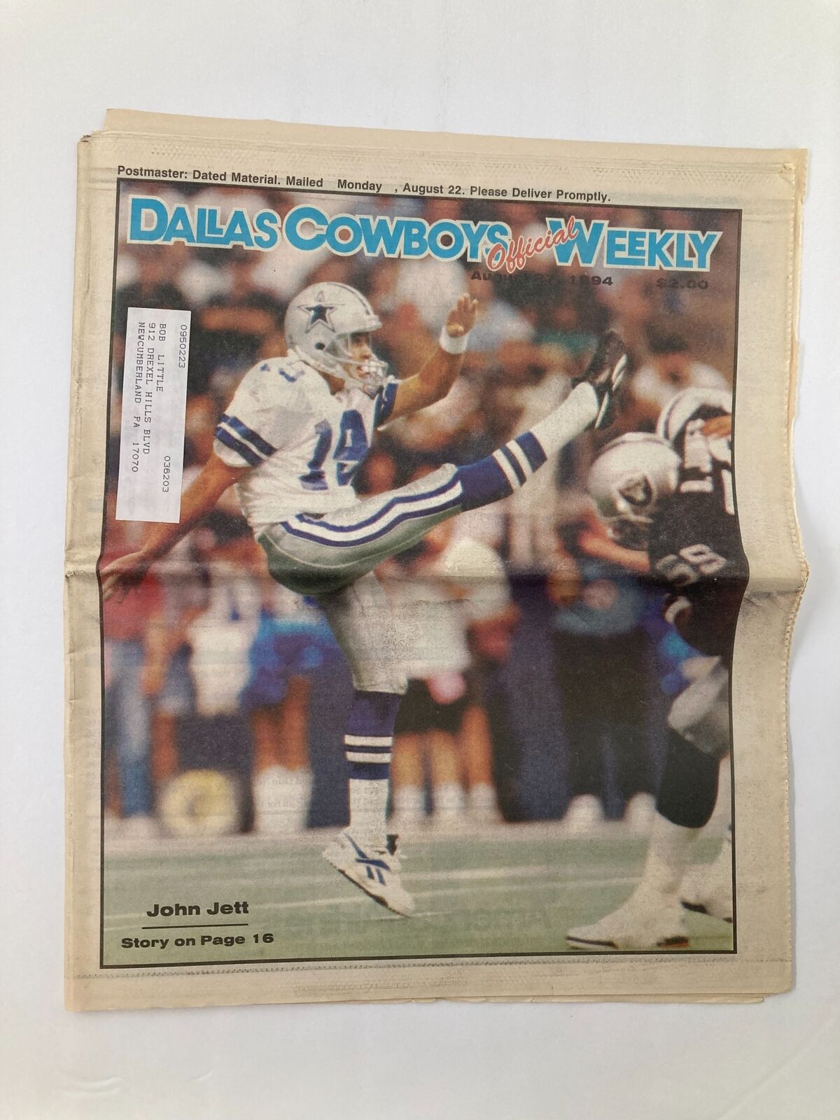 Dallas Cowboys Weekly Newspaper August 27 1994 Vol 20 #11 featuring John Jett on the cover. The newspaper showcases the football player in action, emphasizing the team's iconic blue and silver colors.