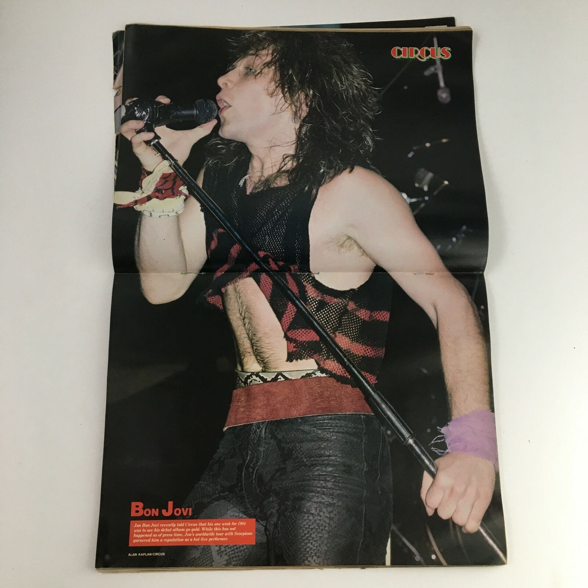 Foldout image of Jon Bon Jovi performing live, featured in Circus Magazine December 31, 1984, showcasing the energy and style of 1980s rock concerts.