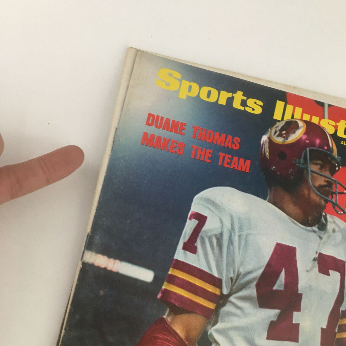 Close-up of Sports Illustrated Magazine August 27, 1973 cover highlighting Duane Thomas with the text 'MAKES THE TEAM', capturing the essence of his sports achievement.