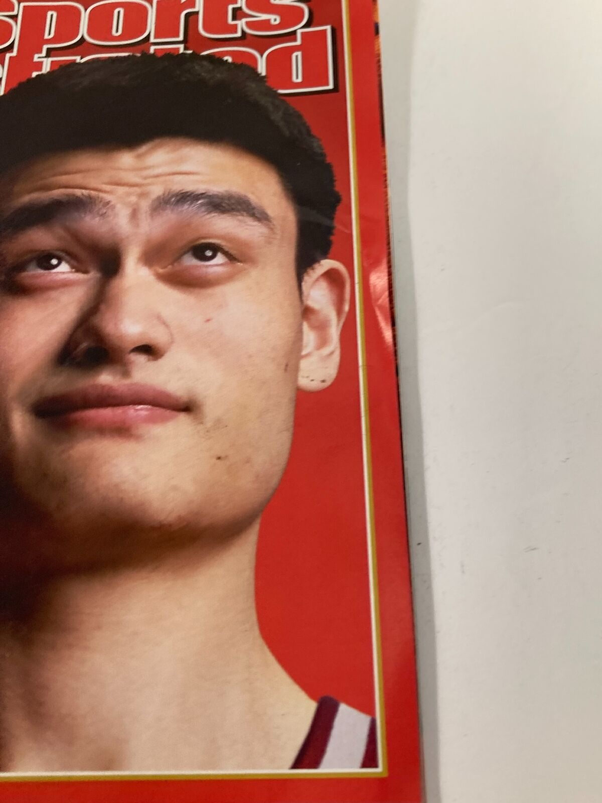 Close-up of Yao Ming on the Sports Illustrated Magazine cover from February 10, 2003, highlighting his thoughtful expression.