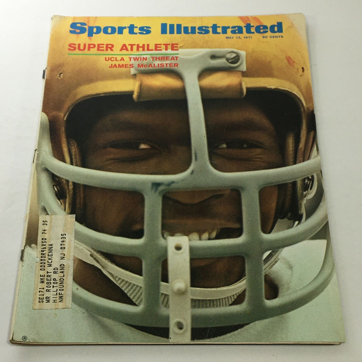 Cover of Sports Illustrated from May 17, 1971 featuring Super Athlete UCLA Twin Threat James McAlister, highlighting his joyful expression while wearing a football helmet.