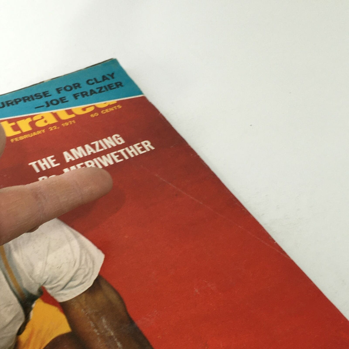 Close-up view of the Sports Illustrated cover dated February 22, 1971, highlighting the title 'The Amazing Dr. Meriwether' and featuring a finger pointing at the text.