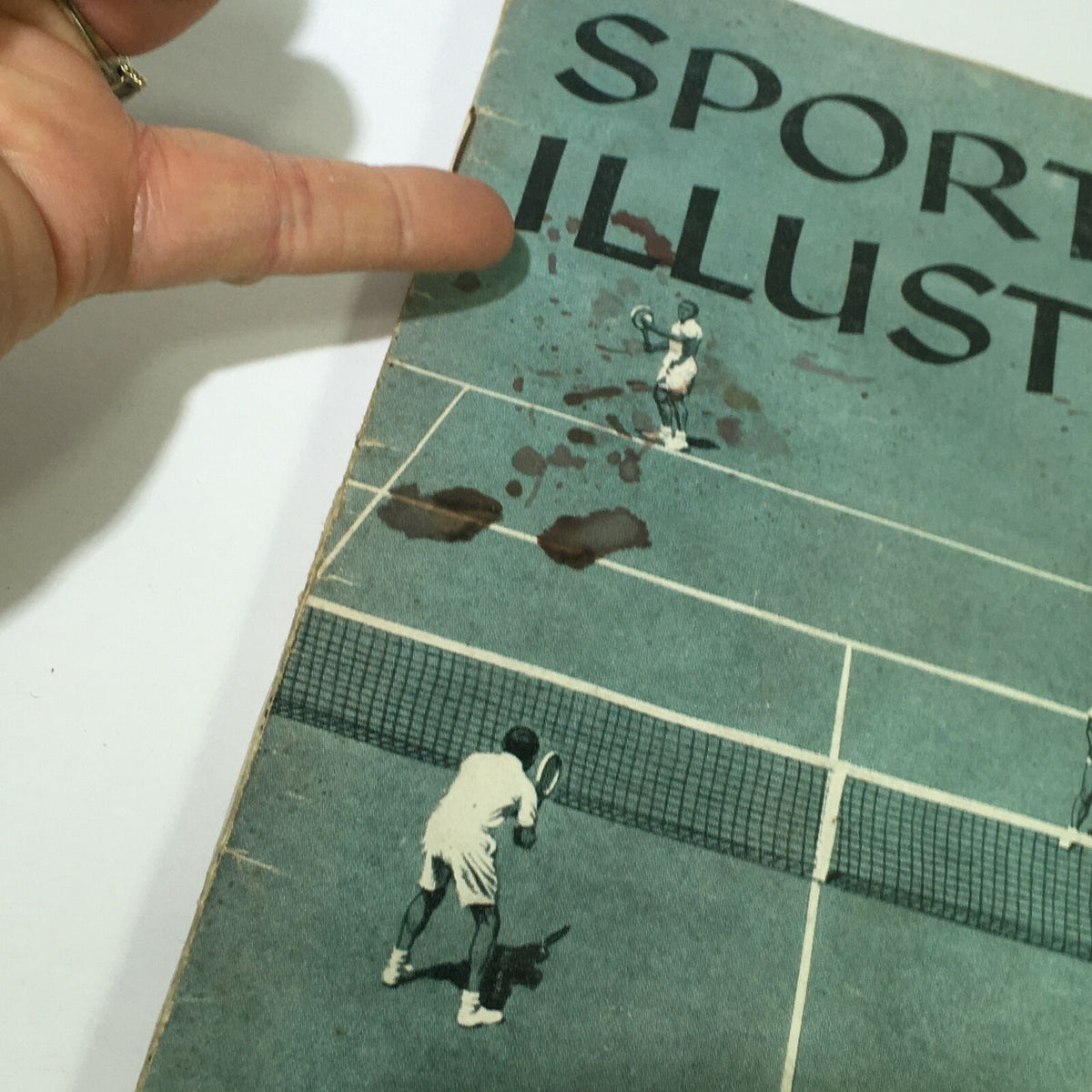 Close-up of the cover of VTG Sports Illustrated Magazine from June 30, 1958, highlighting a tennis player illustration and vintage stains, part of the article 'The Golden Rules of Mixed Doubles' by William F. Talbert.
