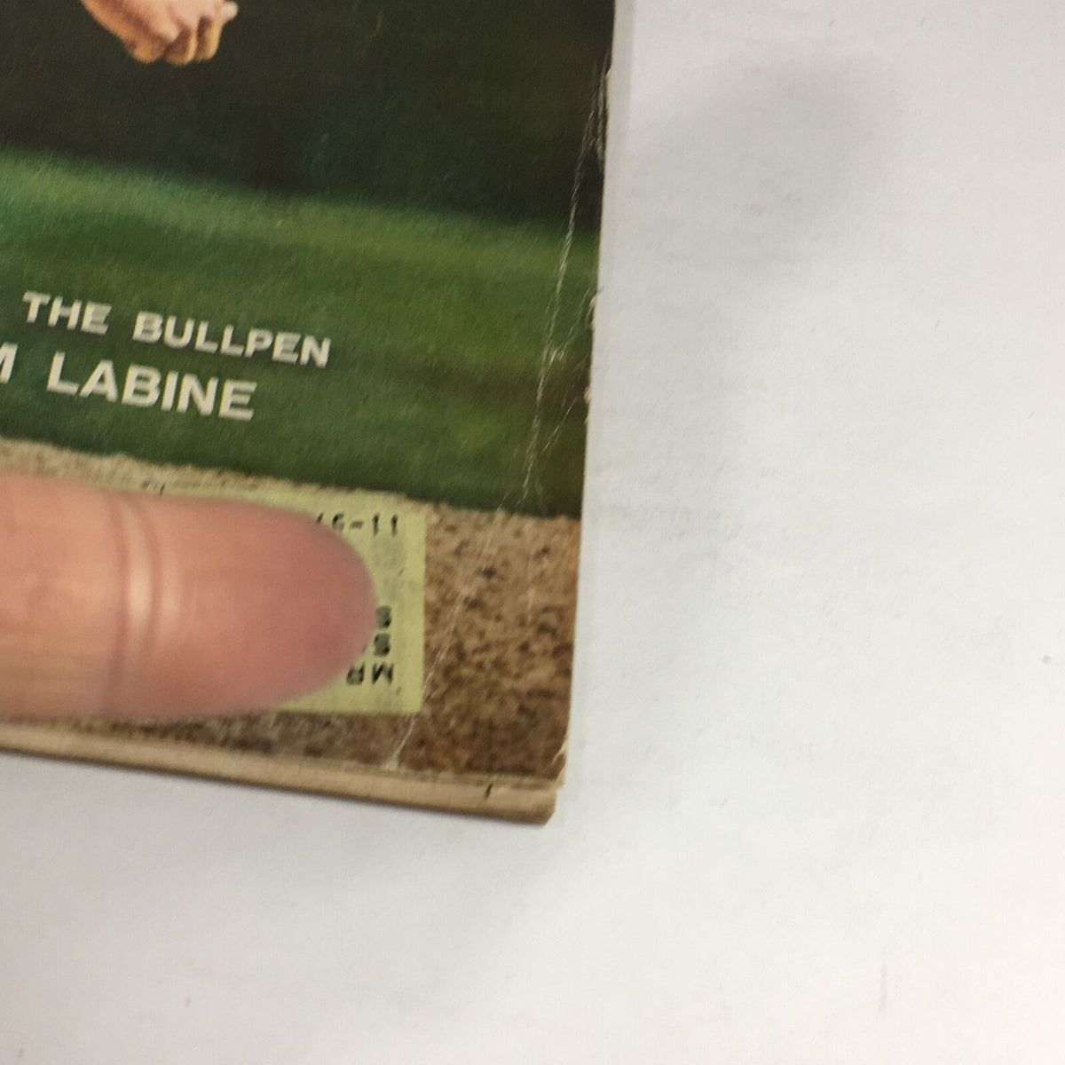 Close-up of the cover details on the vintage Sports Illustrated magazine from June 3, 1957 featuring Clem Labine. The image highlights a price sticker and corner wear, indicative of the magazine's age and collectible nature.