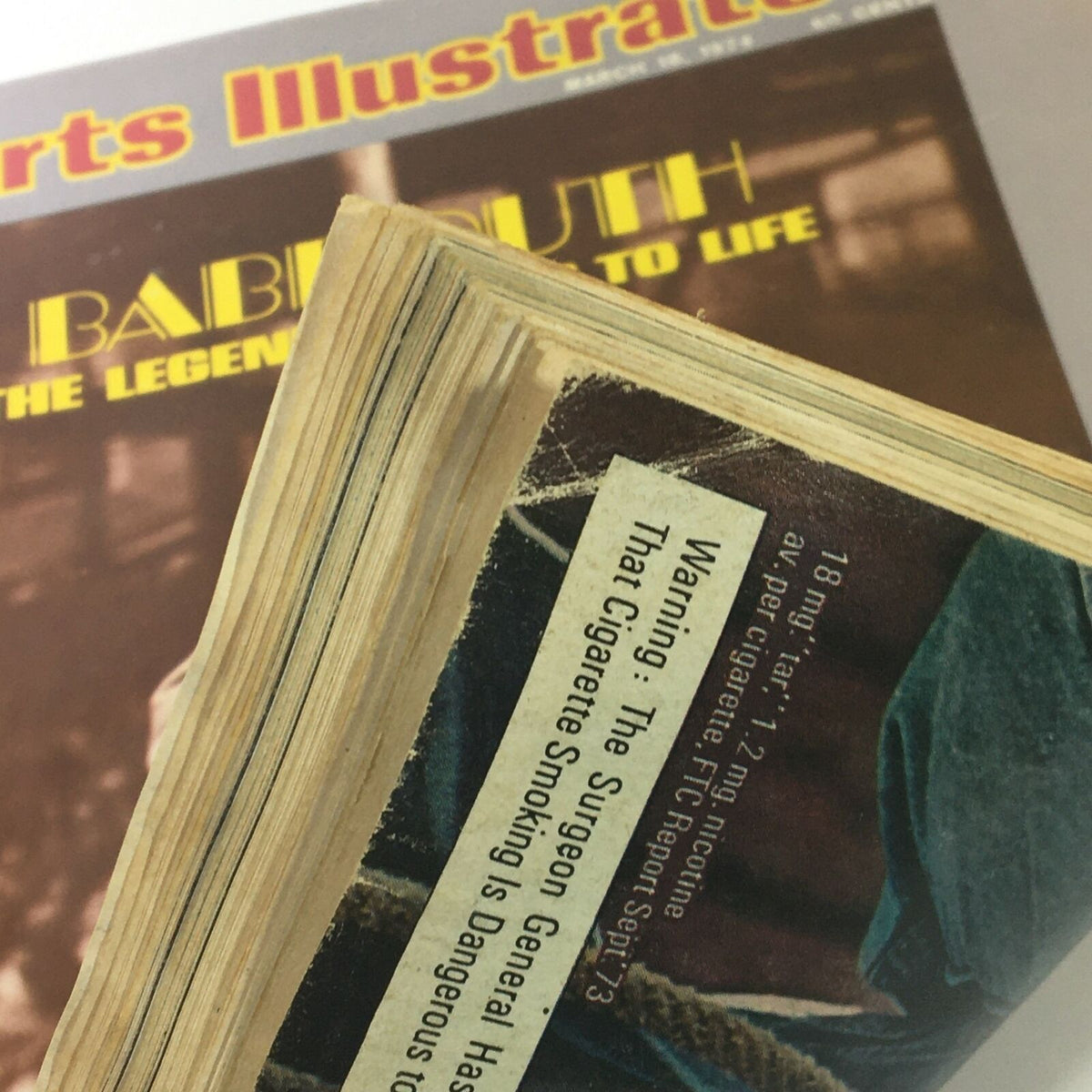 Image capturing the spine of the Sports Illustrated magazine dated March 18, 1974, highlighting the vintage look with evidence of age, including worn edges, and featuring Babe Ruth Jr. on the cover.