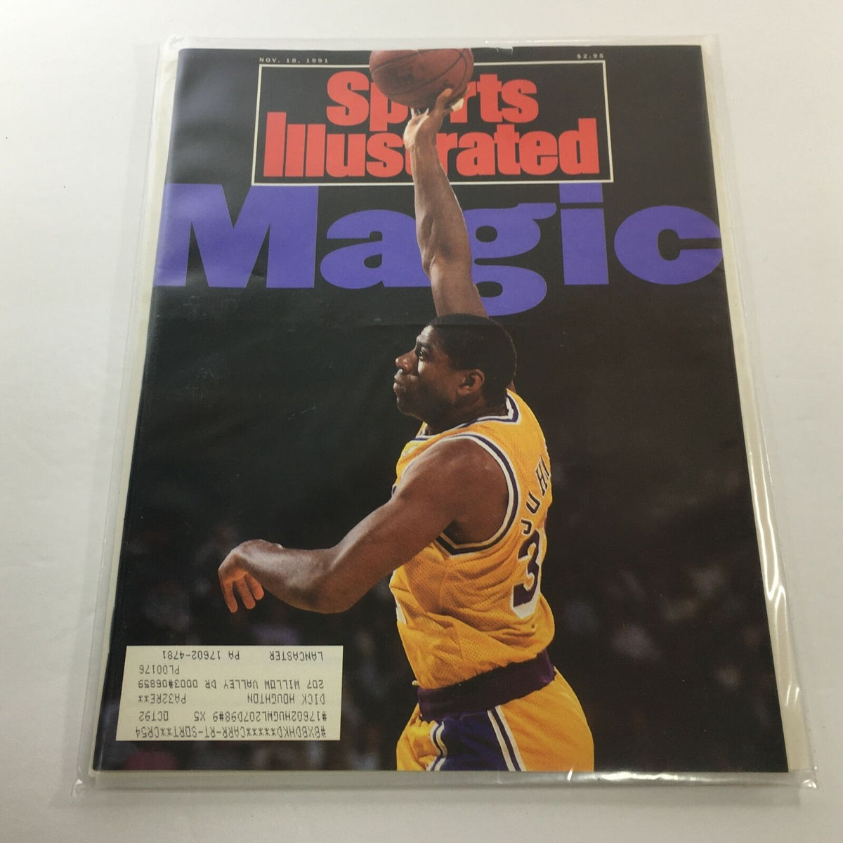 'Sports Illustrated' cover featuring NBA L.A. Lakers player Ervin "Magic" Johnson, showcasing his iconic jump shot, dated November 18, 1991. This magazine is in excellent condition, featuring vivid colors and a protective plastic covering.