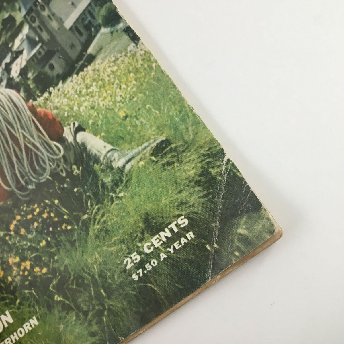 Close-up of the bottom corner of Sports Illustrated Magazine July 25, 1955, showing price details and some wear, highlighting its vintage condition.