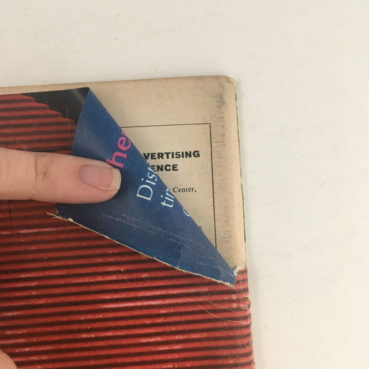 Close-up of the back cover of Sports Illustrated Magazine, April 19, 1965, exhibiting peeling along the edge, representing the age and authenticity of the magazine.