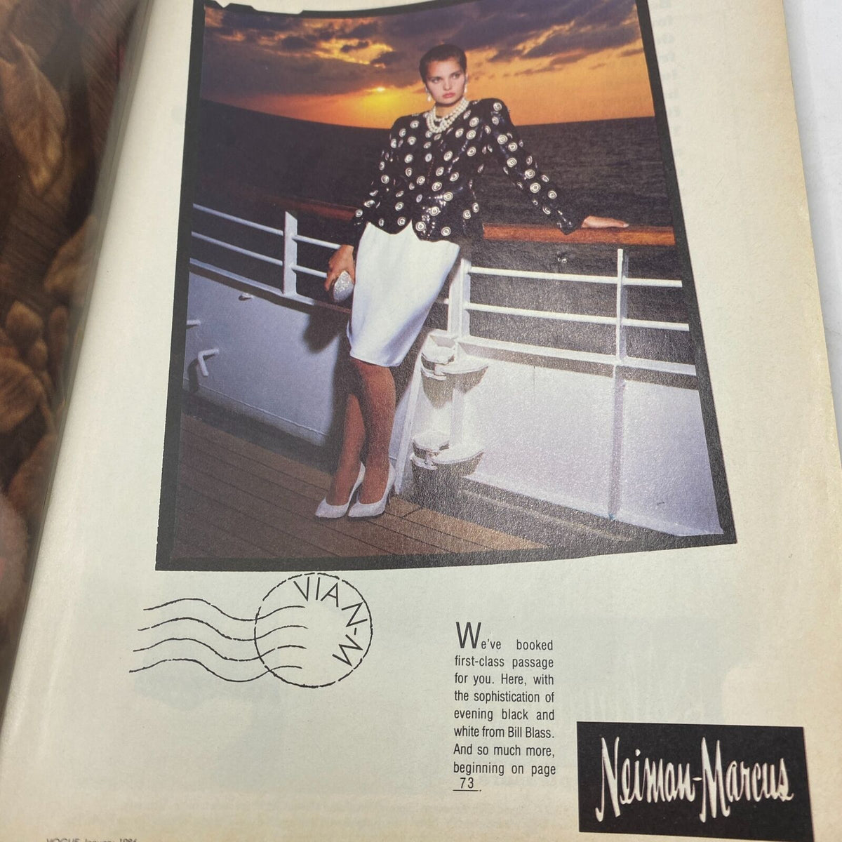 Full-page advertisement from the January 1986 issue of Vogue magazine, featuring a model in a stylish black and white outfit, with a sunset backdrop and the Neiman Marcus logo. A representation of luxury fashion in the 1980s.