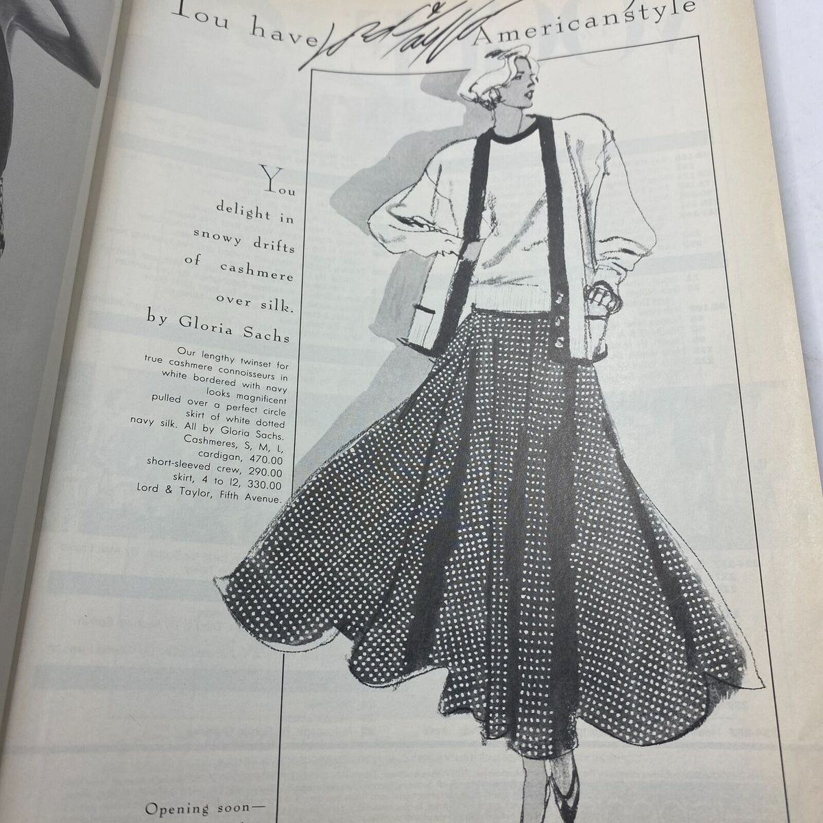 Illustrated advertisement from the January 1986 issue of Vogue magazine, showcasing a fashion design featuring cashmere and silk, by Gloria Sachs. Highlights vintage American fashion styles from the 1980s.