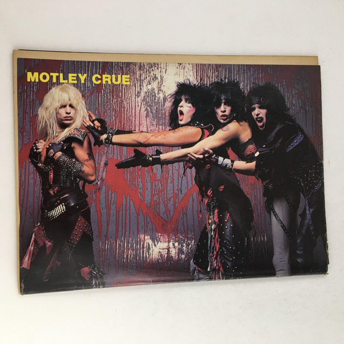 A vibrant promotional poster of Motley Crue featured in Rock Fever Magazine June 1985, Vol 2 #2, showcasing the band in their iconic style during the 1980s rock era.
