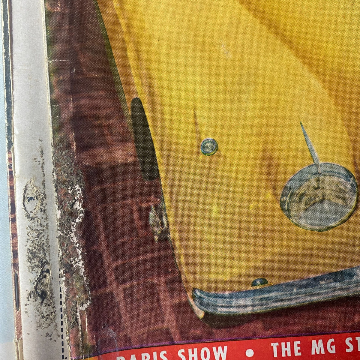 Lot of 12 Road & Track Magazines 1954, highlighting a close-up of a vintage car cover from the Paris Show, emphasizing classic automotive design.
