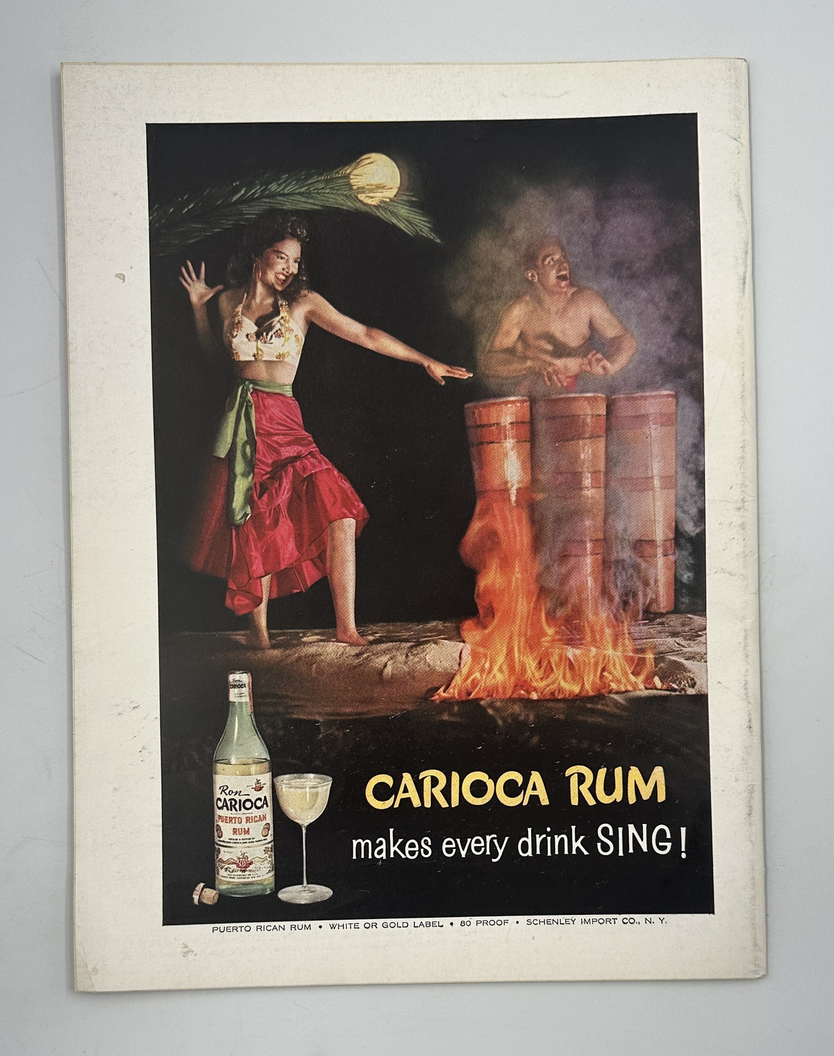 The New Yorker Magazine August 8, 1959 Chef Kitchen Perry Barlow Cover, interior Carioca Rum advertisement showing a dancer, flaming drums, rum bottle, and the slogan “makes every drink SING!”.