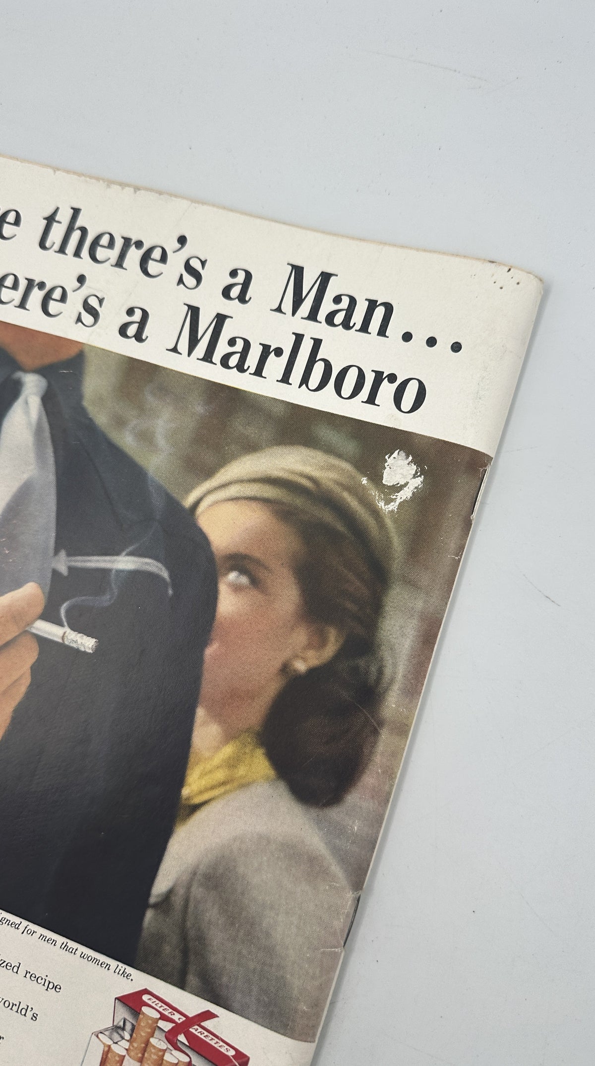 The New Yorker Magazine May 24, 1958 Mexican Market Sombrero Robert Kraus Cover showing a close-up of an interior Marlboro cigarette advertisement with a woman and cowboy.