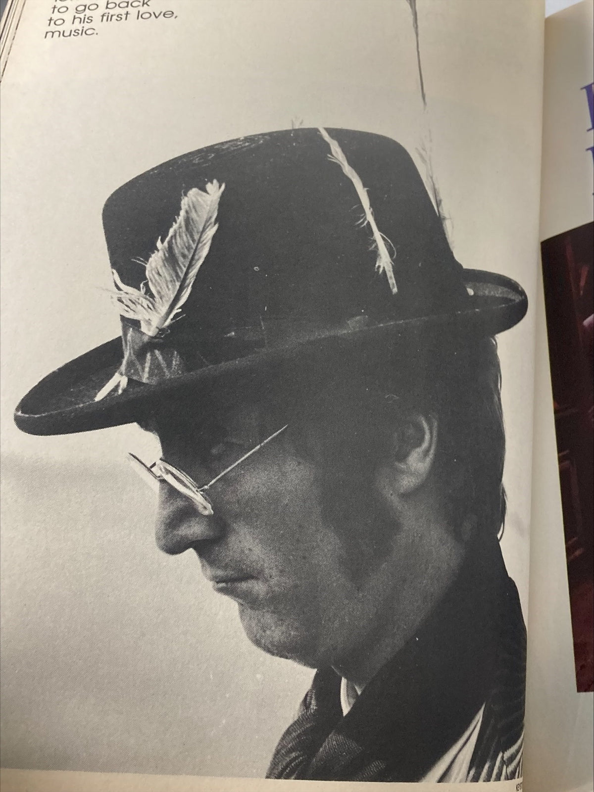 Black and white image of John Lennon in profile, wearing a feathered hat and glasses, featured in the 1981 The Beatles' John Lennon Yoko Ono A Memorial Album.