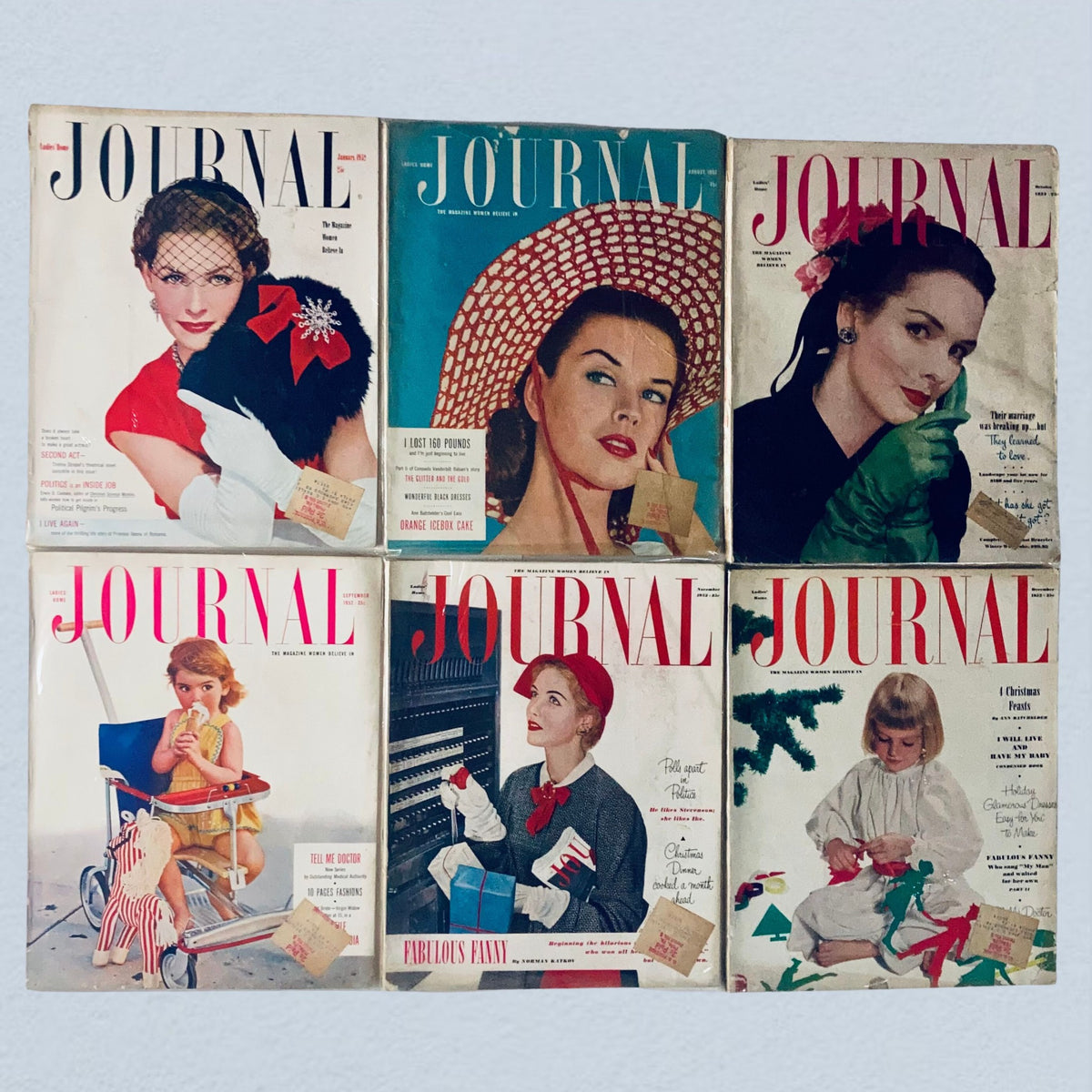 Collection of vintage 1952 Ladies' Home Journal magazines featuring colorful cover designs and fashion advertisements. The lot includes six issues highlighting mid-century styles, showcasing women in fashionable attire.