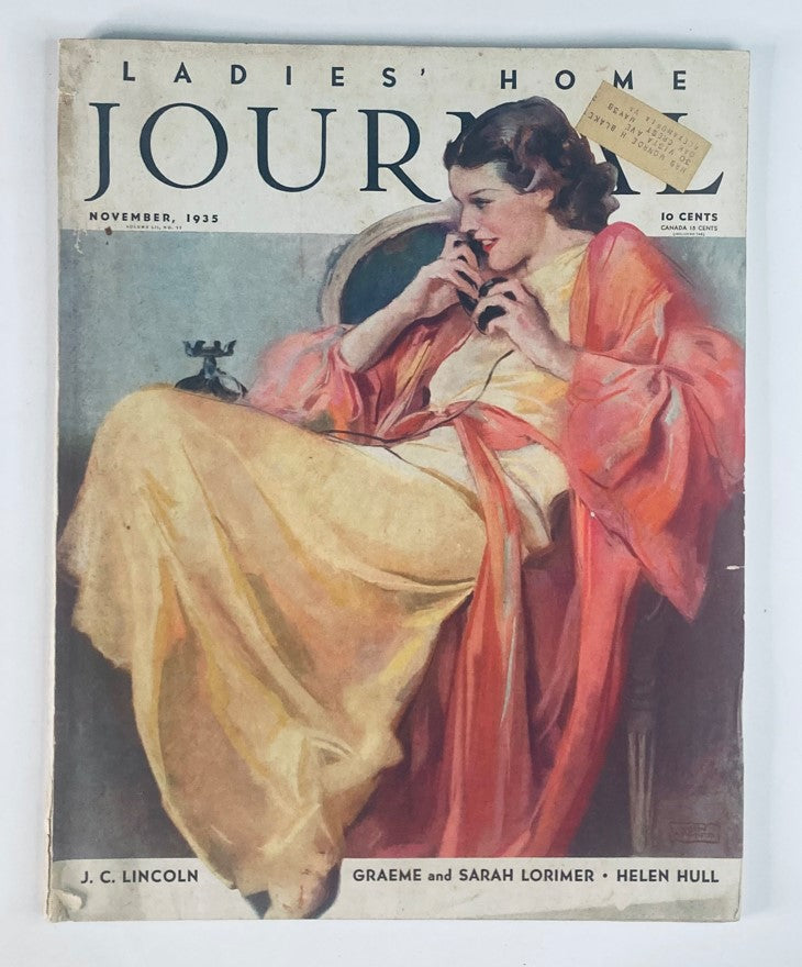 Cover of Ladies' Home Journal Magazine November 1935 featuring a woman in vintage fashion using a telephone, showcasing 1930s style and design.