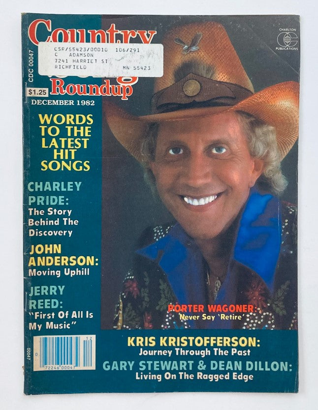 Cover of Country Song Roundup Magazine from December 1982 featuring Porter Wagoner with the phrase 'Never Say Retire', detailing articles about Charley Pride and John Anderson.