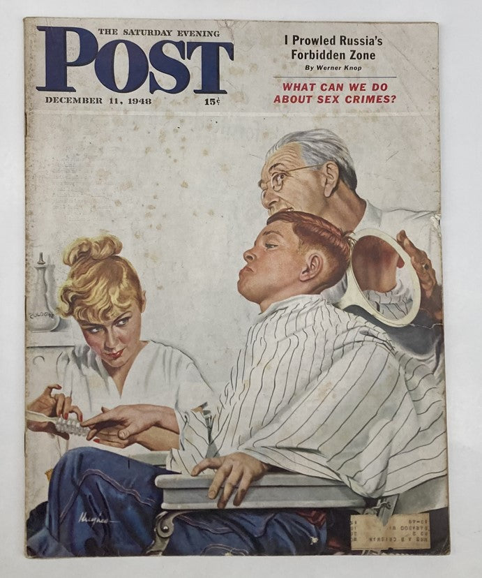 Cover of the Saturday Evening Post Magazine December 11 1948 featuring an illustrated image by George Hughes, depicting a barbershop scene with a boy getting a haircut and adults in the background.