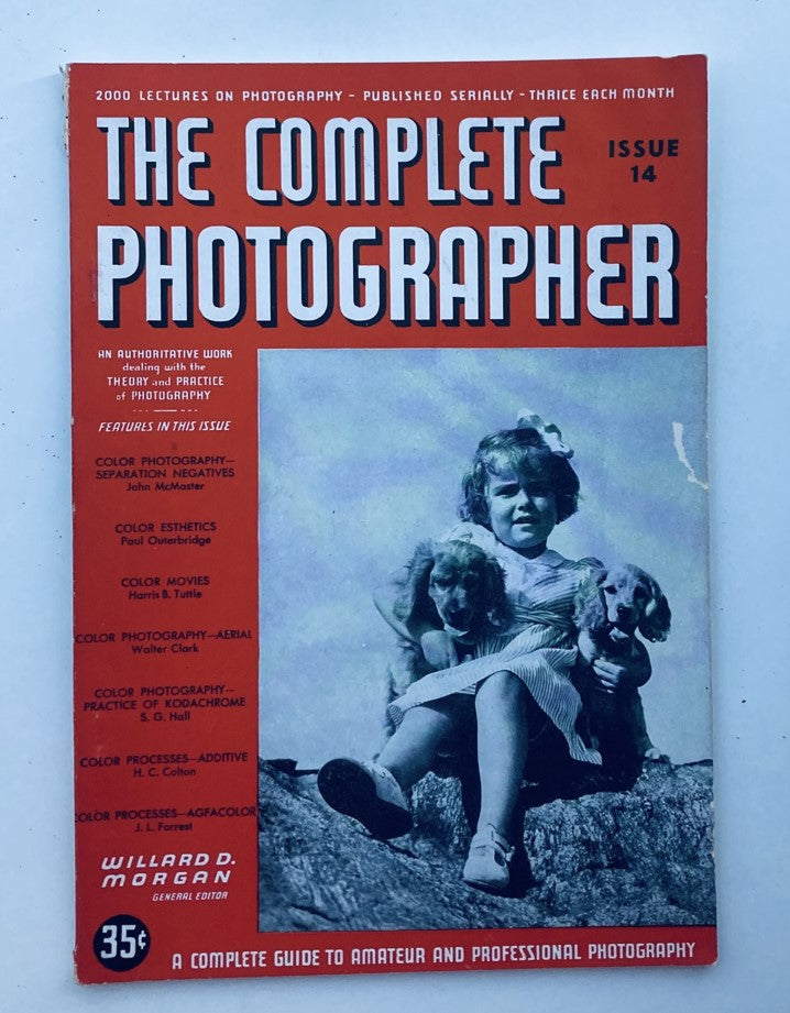 Cover of The Complete Photographer Magazine, January 30, 1942, showcasing color esthetics and featuring a girl with two dogs, highlighting vintage photography techniques and insights.