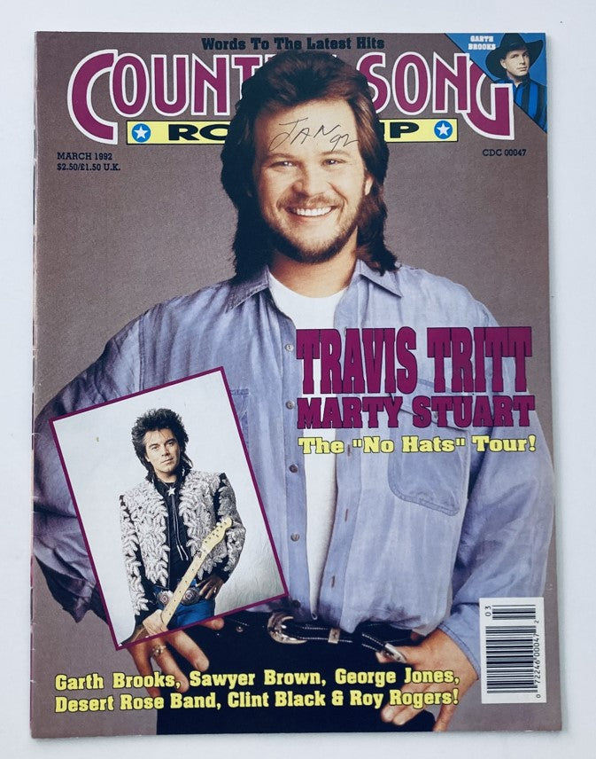 Cover of Country Song Roundup Magazine March 1992 featuring Travis Tritt and Marty Stuart, showcasing the title 'Country Song Roundup' with a vibrant graphic design.