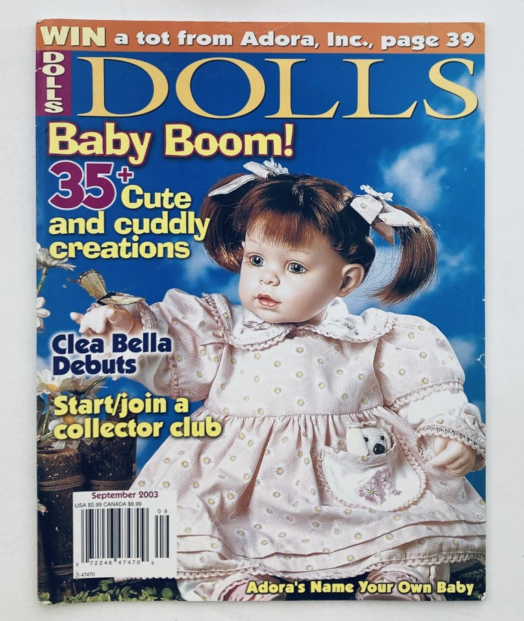 Dolls Magazine September 2003, Volume 22, Number 7 cover featuring Clea Bella's debut, showcasing a doll in a pink outfit with white polka dots, surrounded by text highlighting doll creations.
