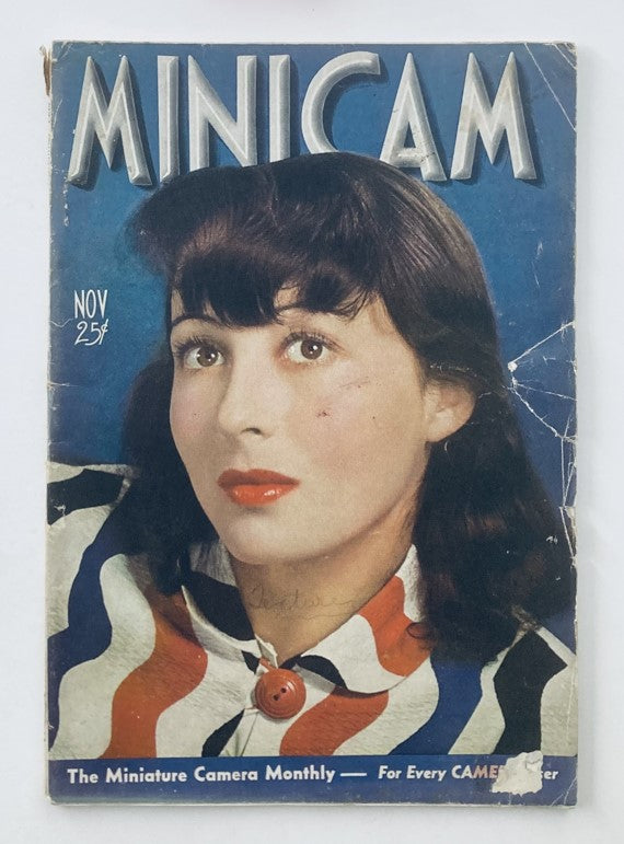 Cover of the VTG Miniature Camera Magazine November 1938 featuring a woman with black hair and red lips, dressed in a colorful striped blouse.