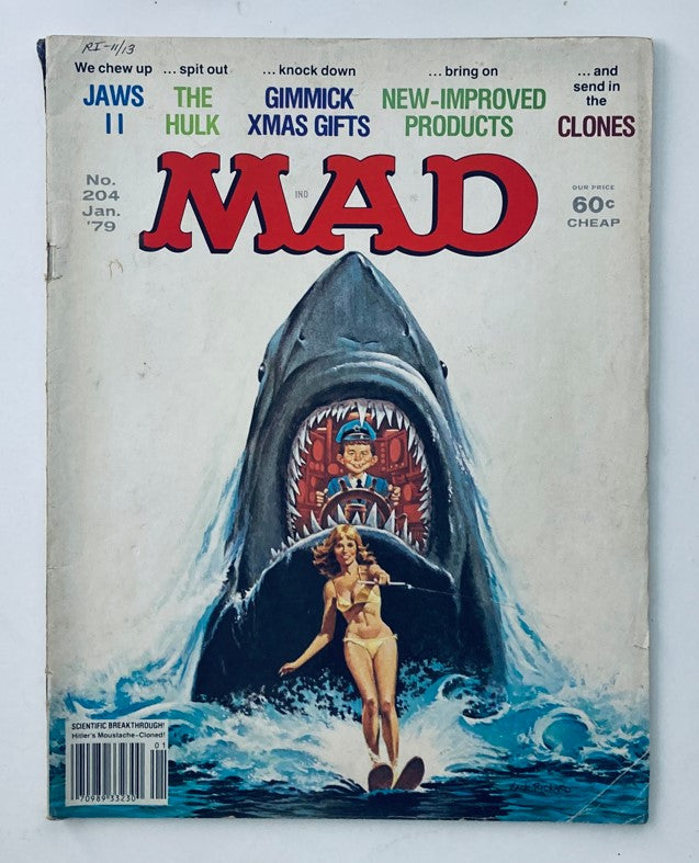 Mad Magazine January 1979 No. 204 featuring Jaws II and The Hulk. The cover showcases a humorous illustration of a shark with a character at the helm, alongside a model in a swimsuit, embodying the magazine's iconic satire. This vintage issue emphasizes classic pop culture and parodies.