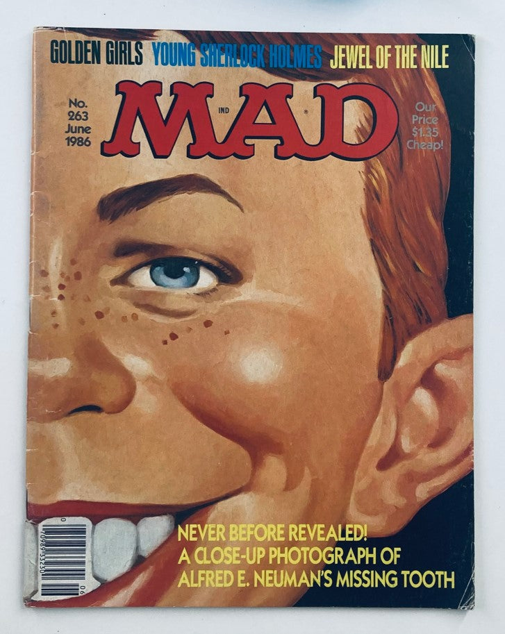 Cover of Mad Magazine June 1986 No. 263 featuring the title 'Mad' prominently displayed, a close-up illustration of Alfred E. Neuman's face with a focus on his missing tooth, under the text 'Never Before Revealed! A Close-Up Photograph of Alfred E. Neuman’s Missing Tooth', and decorated with references to 'Golden Girls' and 'Young Sherlock Holmes'.