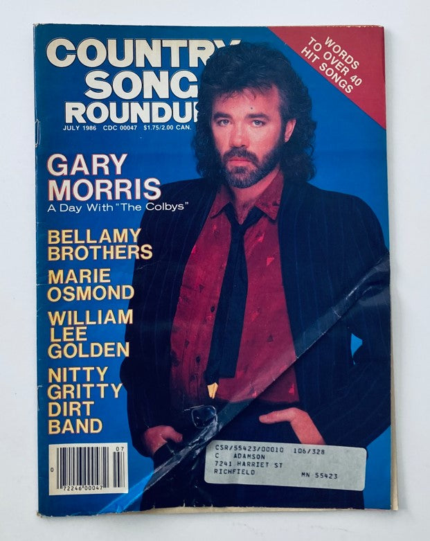 Cover of the VTG Country Song Roundup Magazine from July 1986 featuring Garry Morris, titled 'A Day with The Colbys'. Includes the names of several artists like Bellamy Brothers, Marie Osmond, William Lee Golden, and Nitty Gritty Dirt Band.