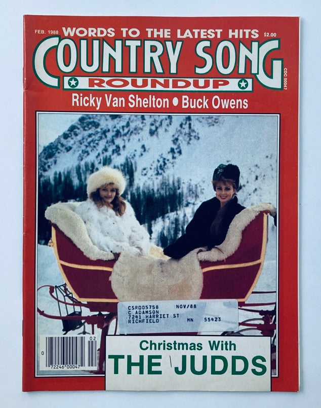 Cover of VTG Country Song Roundup Magazine, February 1988 featuring a Christmas special with The Judds, showcasing two women in winter attire on a sleigh in a snowy landscape.