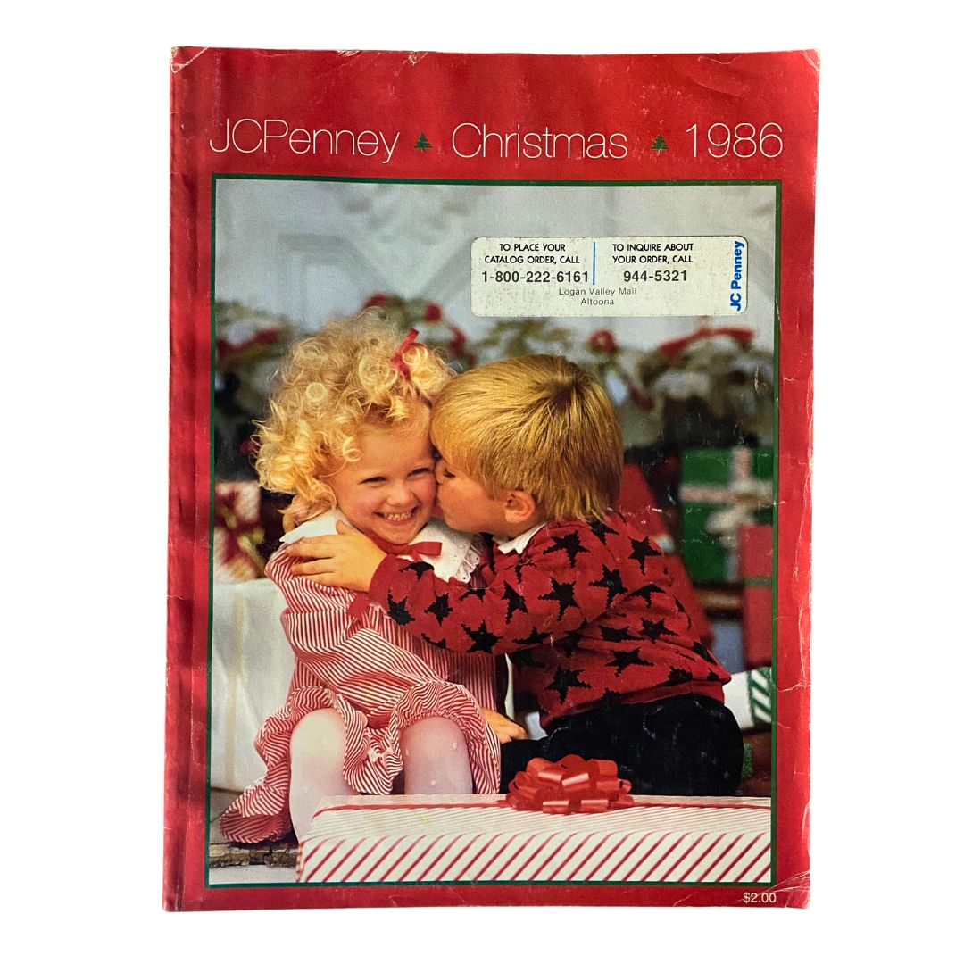 Cover page of the 1986 JCPenney Christmas NFL for The Kids Catalog featuring two children, a boy and a girl, sharing a joyful moment with gifts and holiday decorations.