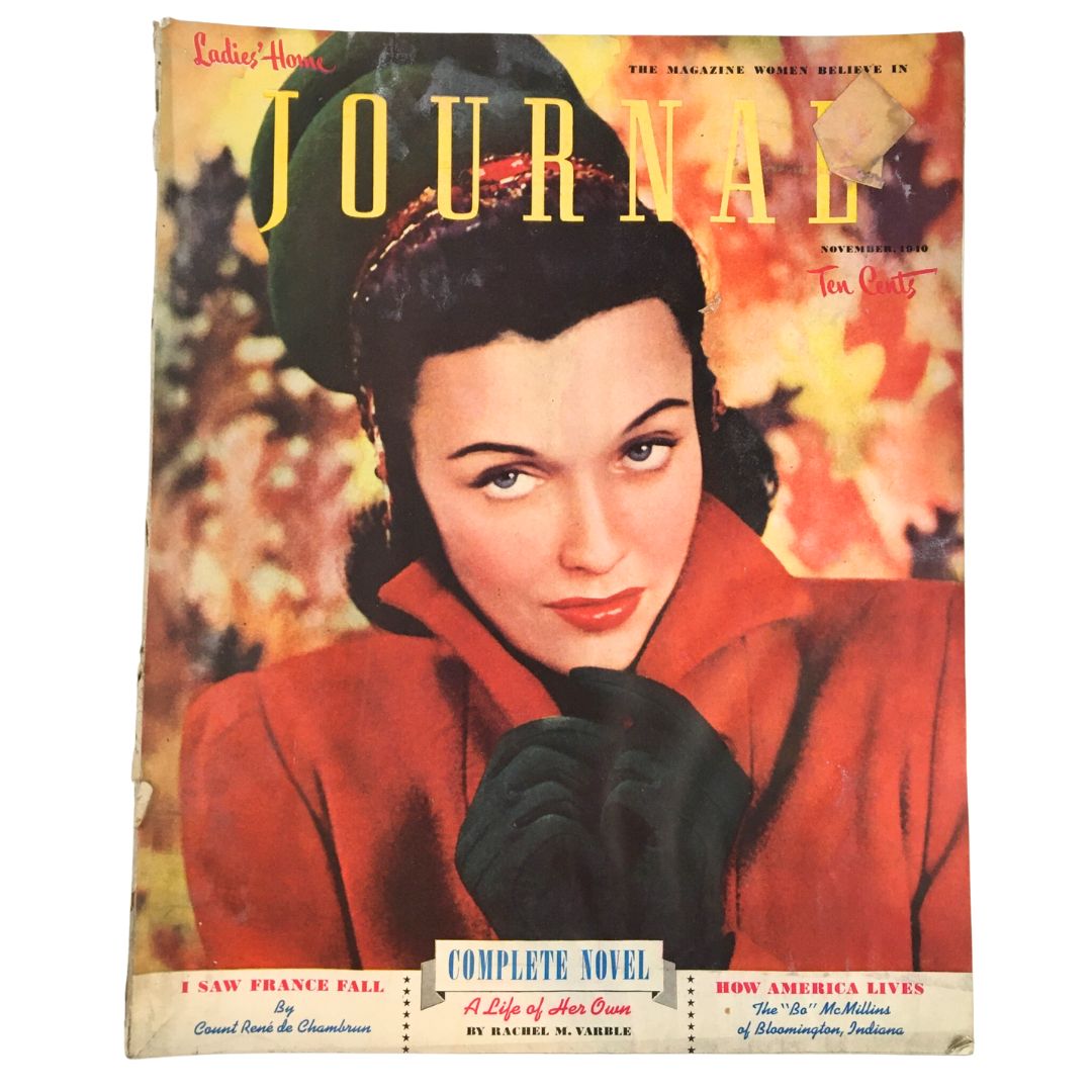 Cover of Ladies Home Journal Magazine November 1910 featuring a stylish woman in winter attire, with articles 'A Life of Her Own' and 'How America Lives' highlighted.