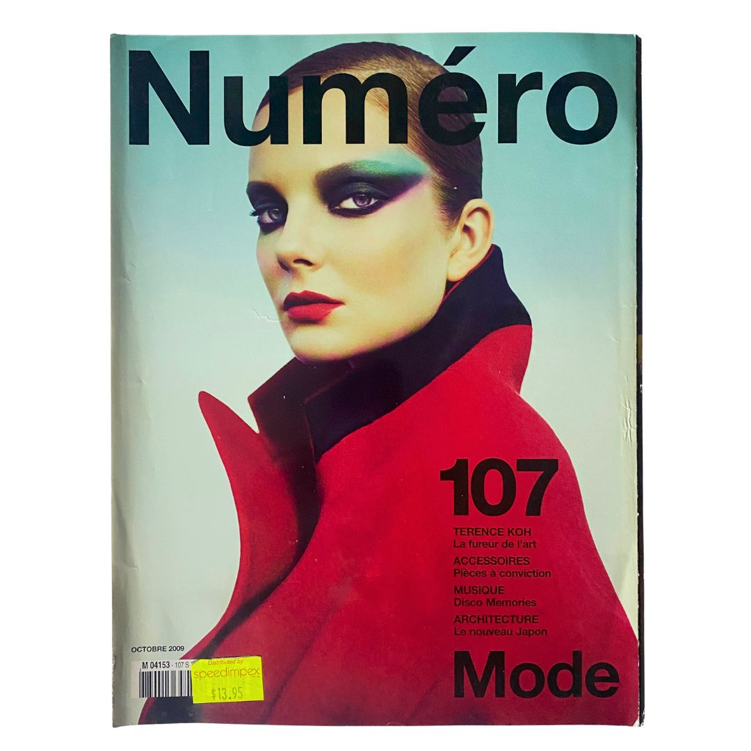 Numéro Magazine October 2009 No. 107 featuring a striking cover image showcasing a model in a bold red coat, embodying high fashion and elegance.