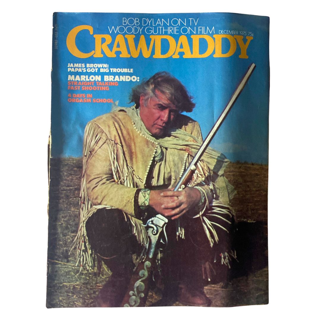 Cover of VTG Crawdaddy Magazine from December 1975 featuring James Brown and Marlon Brando, highlighting cultural icons and articles from the vibrant 1970s music and film scene.