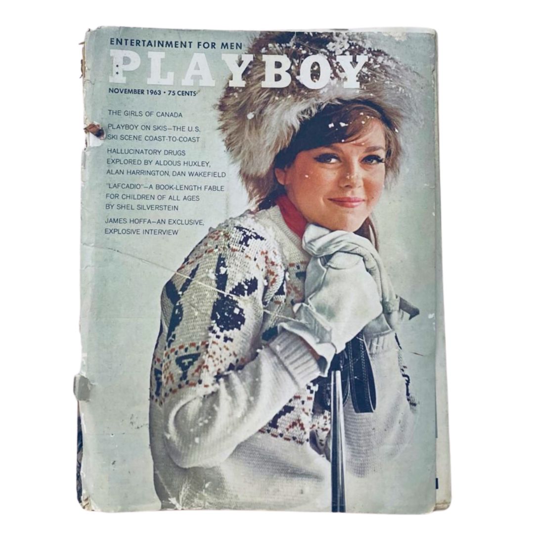 VTG Playboy Magazine November 1963 Covergirl Sharon Rogers featuring a snowy outdoor scene, showcasing Rogers with a fur hat and winter gloves, capturing the vintage allure of this iconic issue.