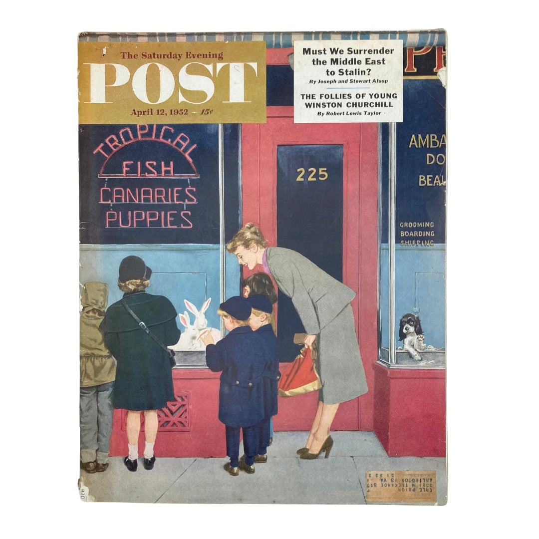 Cover of the Saturday Evening Post Magazine from April 12, 1952, featuring a charming illustration of children looking at Easter Bunnies in a shop window, emphasizing springtime festivities and vintage Americana.