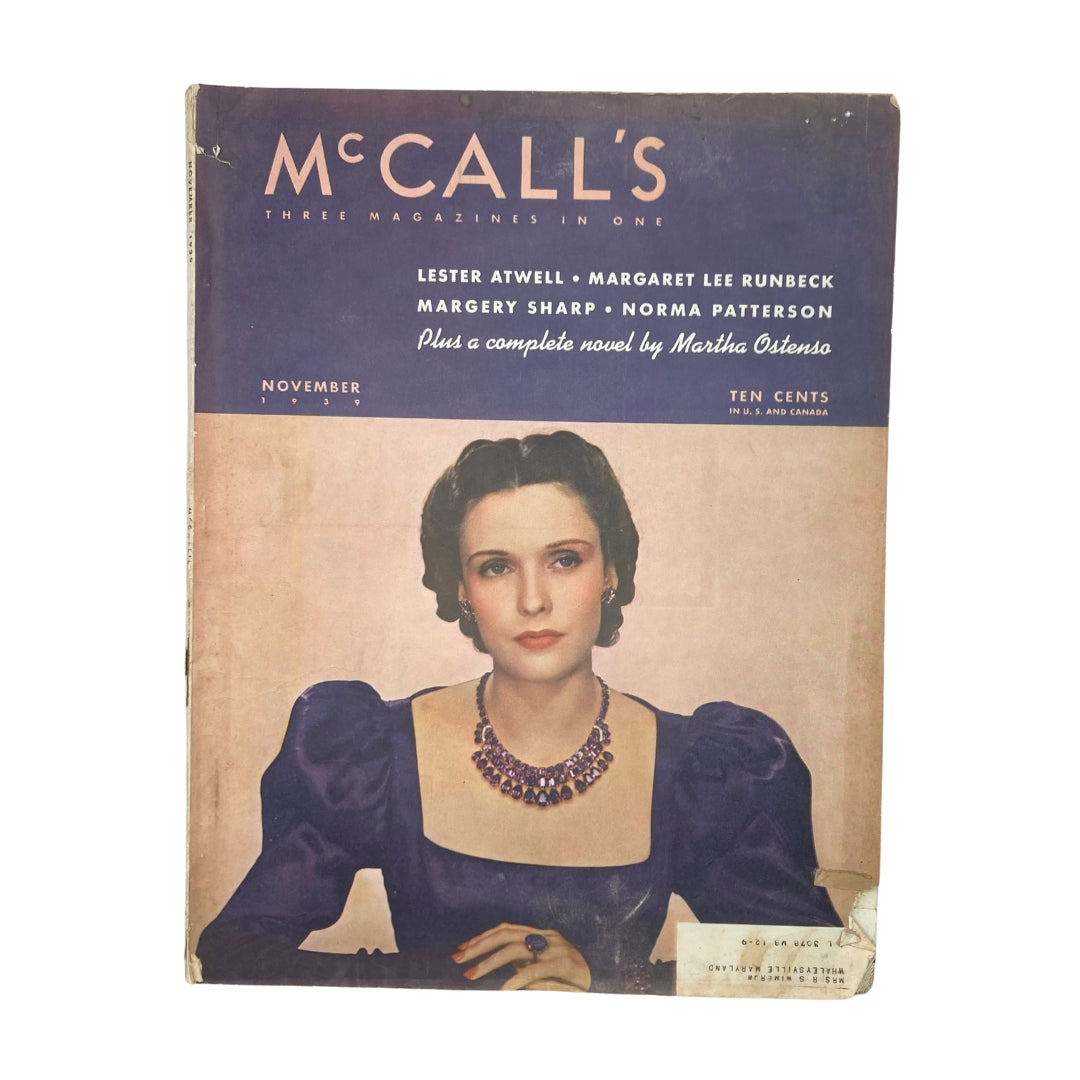 Cover of VTG McCall's Magazine November 1939 featuring a woman in a purple dress with a statement necklace, showcasing the fashion trends of the late 1930s.