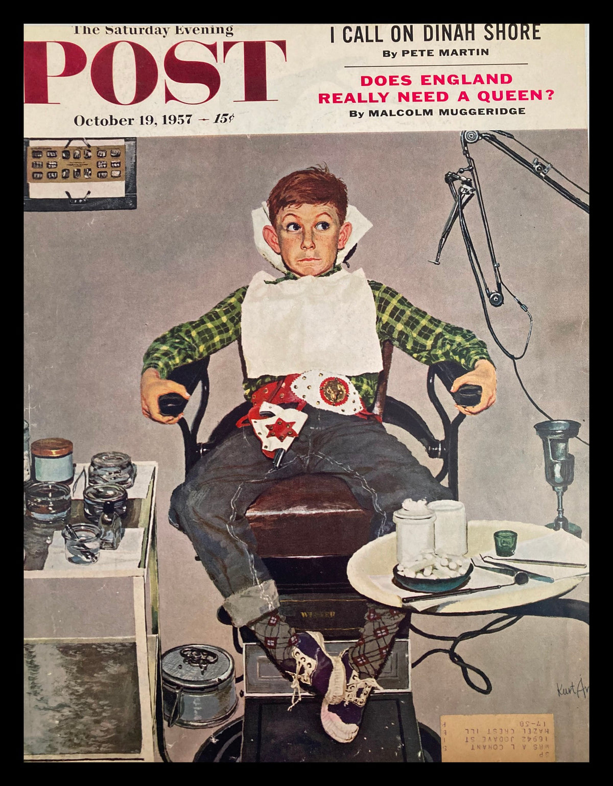 Cover of The Saturday Evening Post from October 19, 1957, featuring a young boy in a barber chair, wearing a bib, with a playful expression, amidst various barber tools and items. Title: I Call On Dinah Shore.
