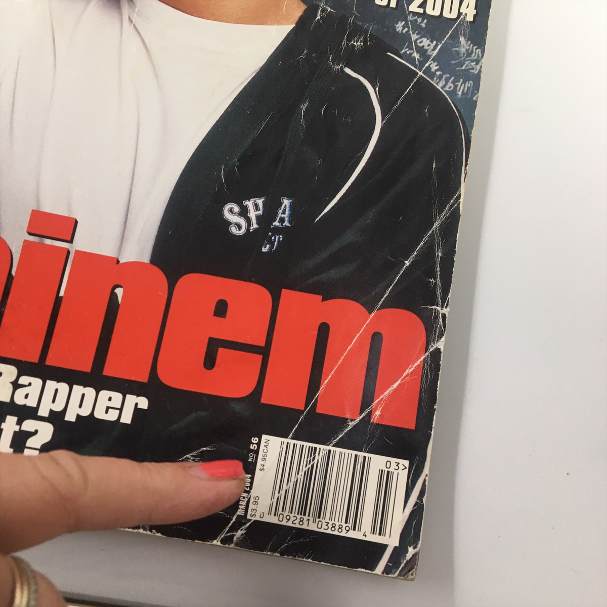 Close-up of the cover of XXL Magazine March 2004 showing Eminem's name prominently, highlighting the magazine's vintage condition with some wear and tear.
