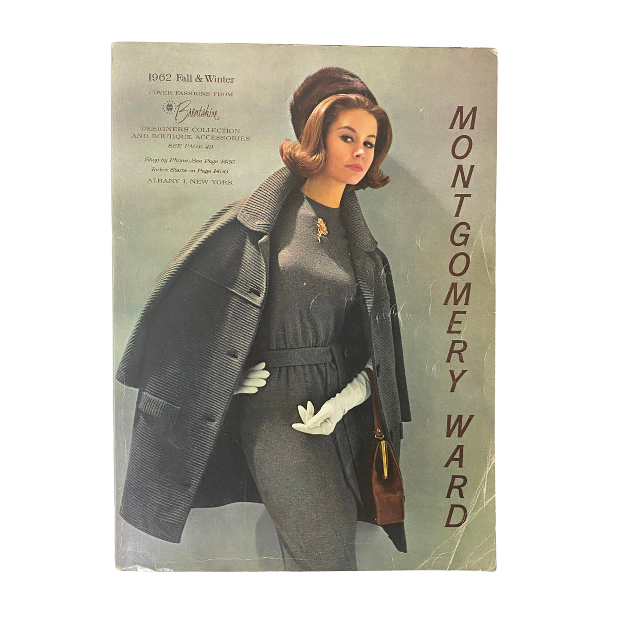 Cover of the 1962 Montgomery Ward Fall and Winter Catalog featuring a fashionable model in a classic wool blend outfit with gloves and a handbag, showcasing vintage 1960s fashion styles.
