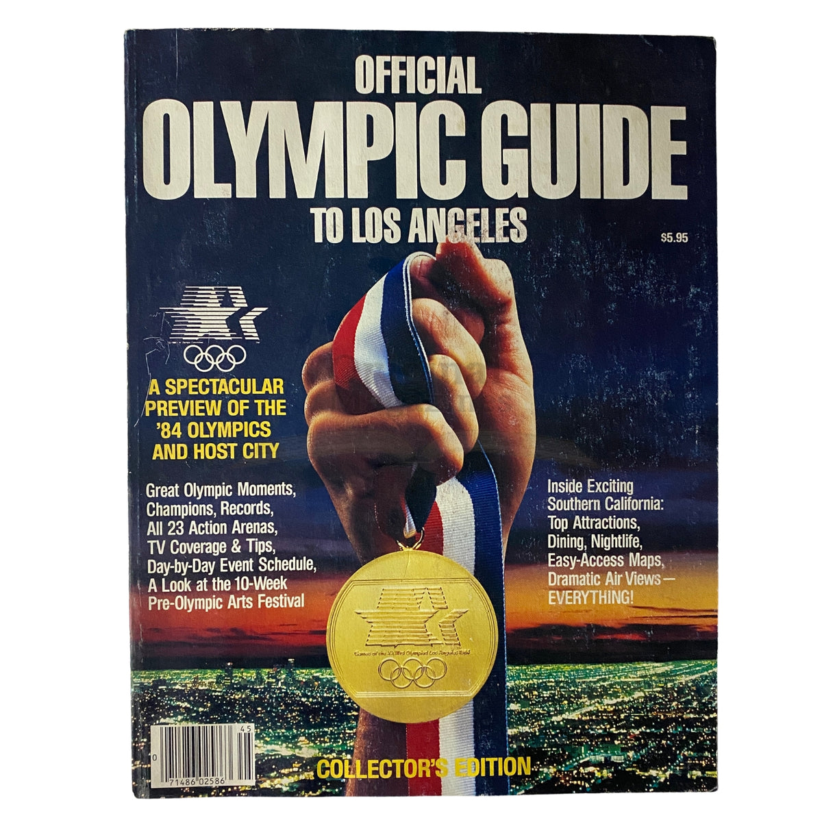 Cover of the 1984 Official Olympic Guide to Los Angeles Collector's Edition, featuring an athlete holding a medal with a stunning sunset backdrop, showcasing key information about the Olympics and host city.