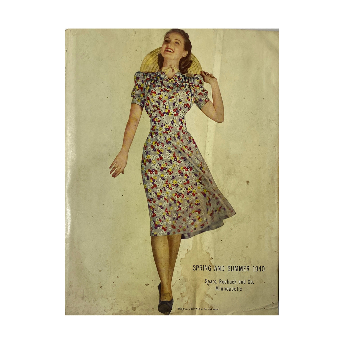Cover of the 1940 Sears Spring and Summer Catalog featuring a woman in a colorful floral dress and a straw hat, showcasing vintage fashion from the era.