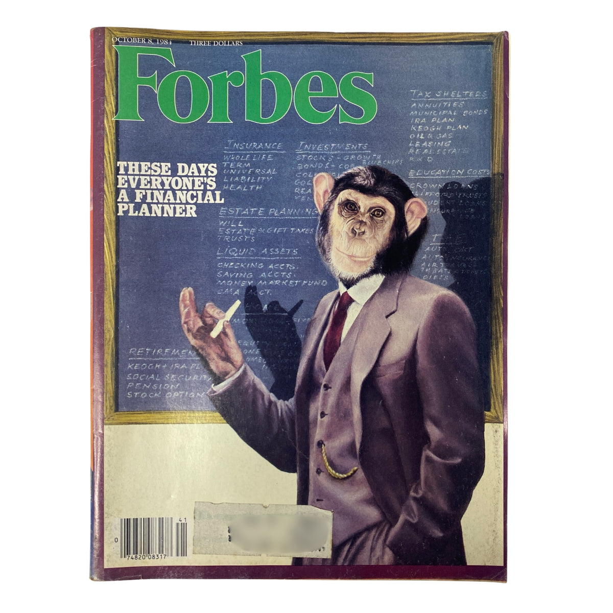 Vintage Forbes Magazine from October 8, 1984, featuring the title 'These Days Everyone's A Financial Planner'. The cover depicts a monkey dressed in a suit, symbolizing financial planning, with financial terms written in the background.