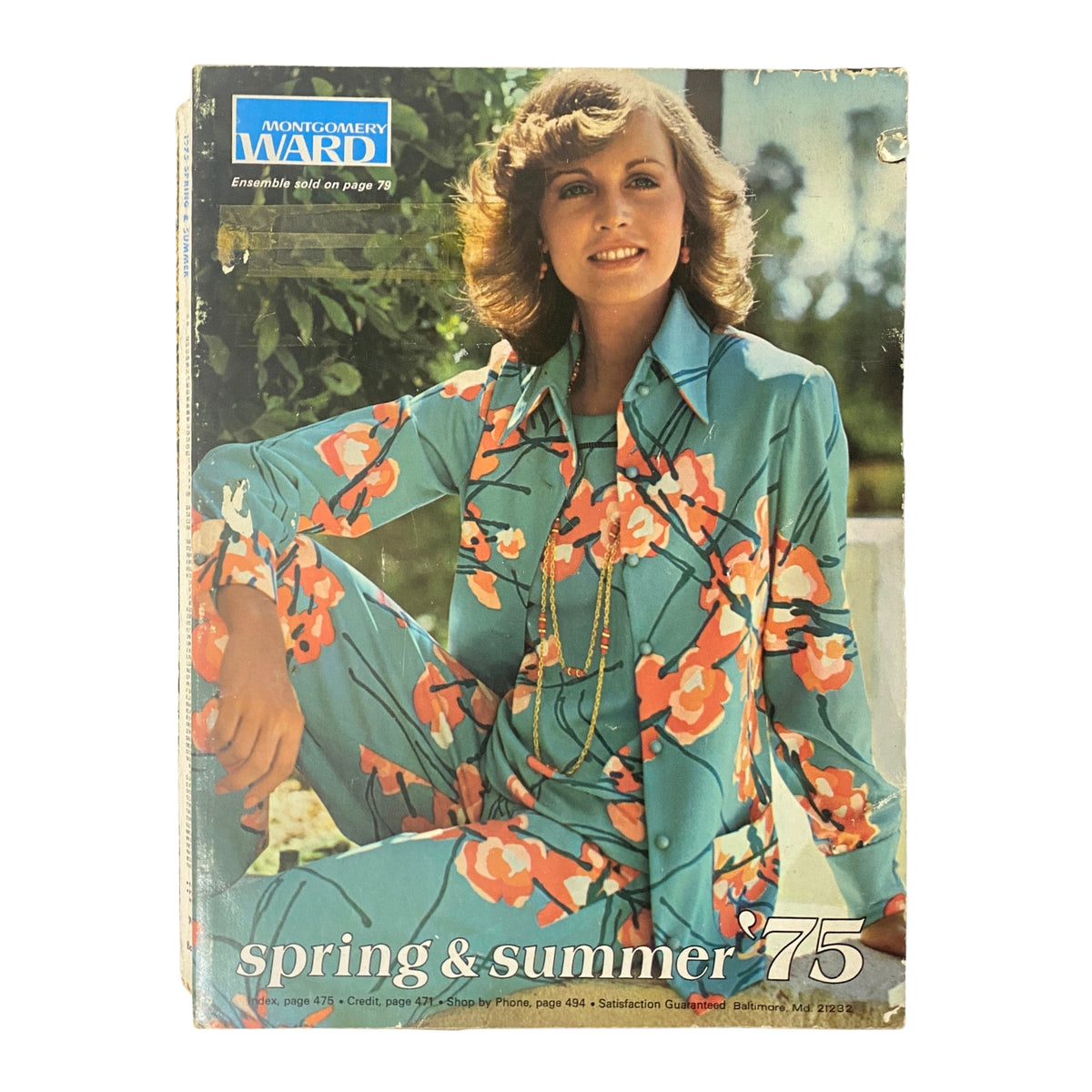 Cover of the 1975 Montgomery Ward Spring and Summer Catalog featuring a model in a vibrant floral-patterned outfit, showcasing mid-1970s fashion trends.