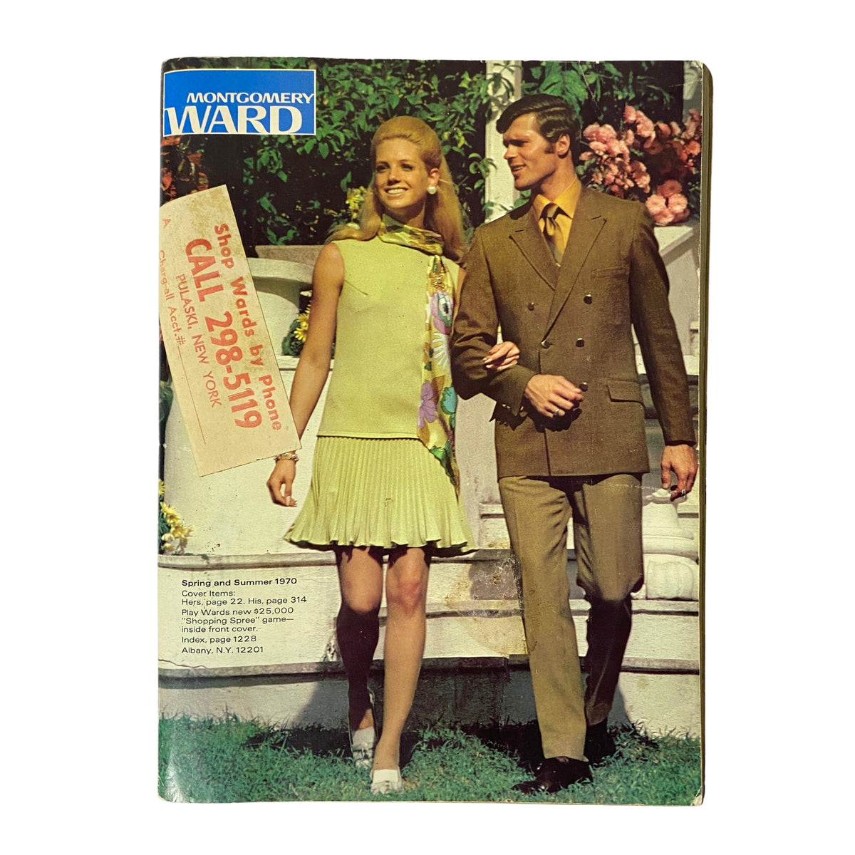 Cover of the 1970 Montgomery Ward Spring and Summer Catalog featuring a fashionable couple. The woman is dressed in a chic green outfit with a pleated skirt and a colorful scarf, while the man is styled in a brown suit. Background includes lush greenery and decorative elements, reflecting the fashion trends of the early 1970s.