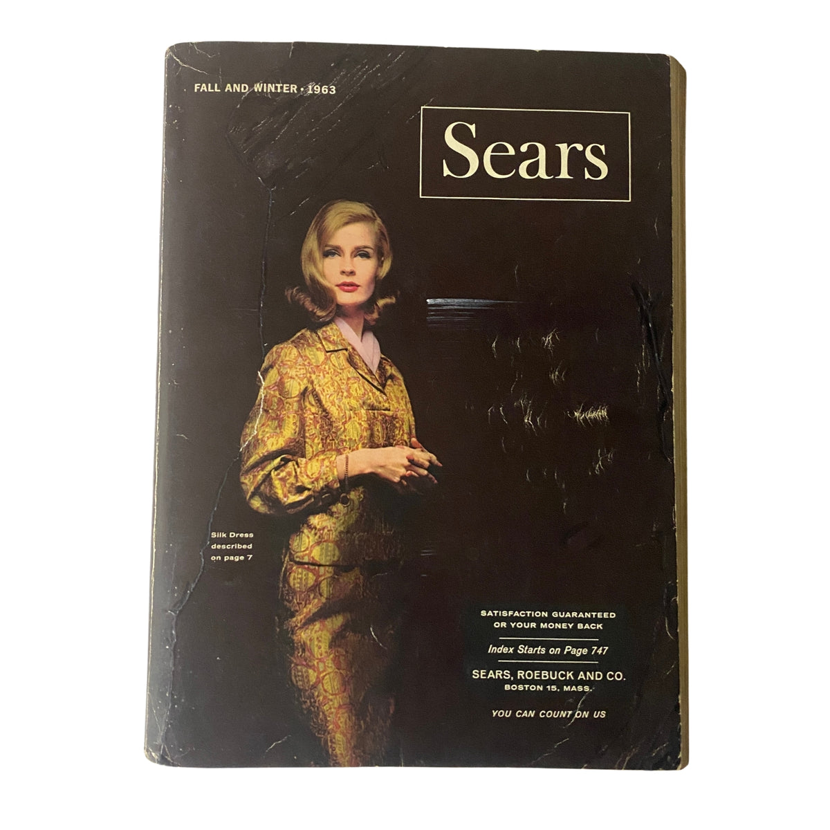 Cover of the 1963 Sears Fall and Winter Catalog featuring a model in a luxurious silk dress, showcasing vintage fashion trends.