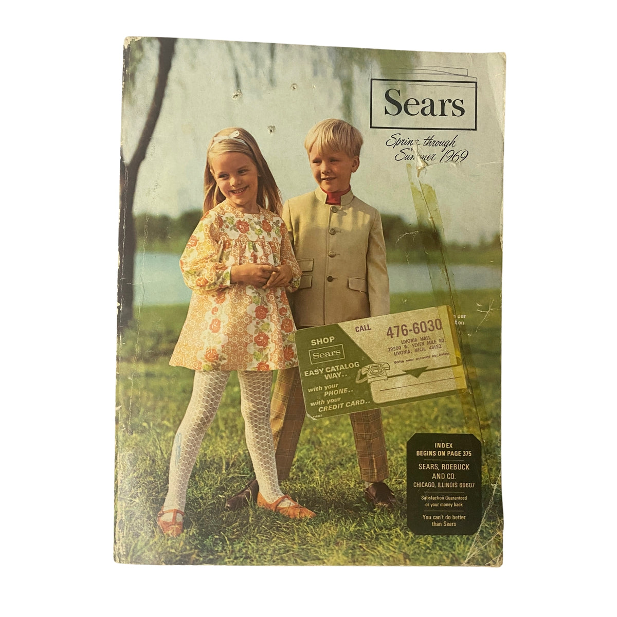 Cover of the 1969 Sears Roebuck and Co. Spring and Summer Catalog featuring children in fashionable attire by a lake.